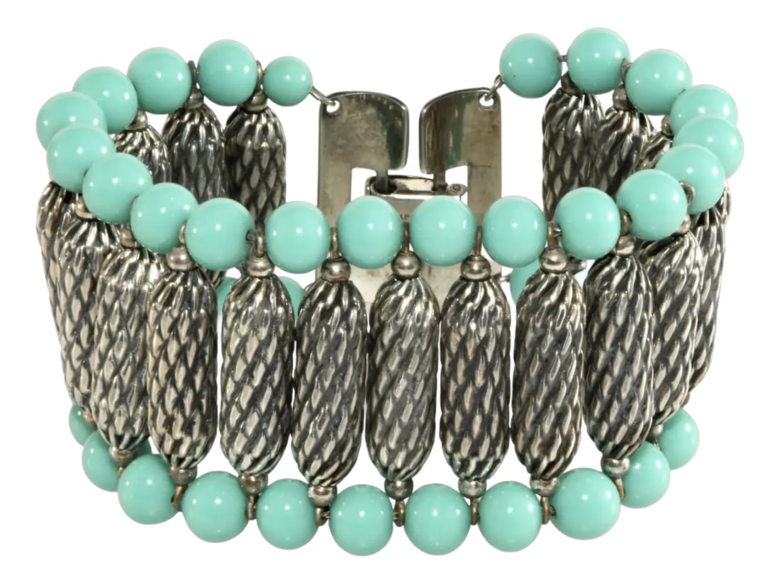 1950s Vintage Napier Silverplated Bracelet With Turquoise Colored Beads: Wide vintage bracelet made with turquoise colored glass and textured silver plated beads strung on fine chain. This high quality piece of 1950s vintage jewelry fastens with a fold over clasp. Marked