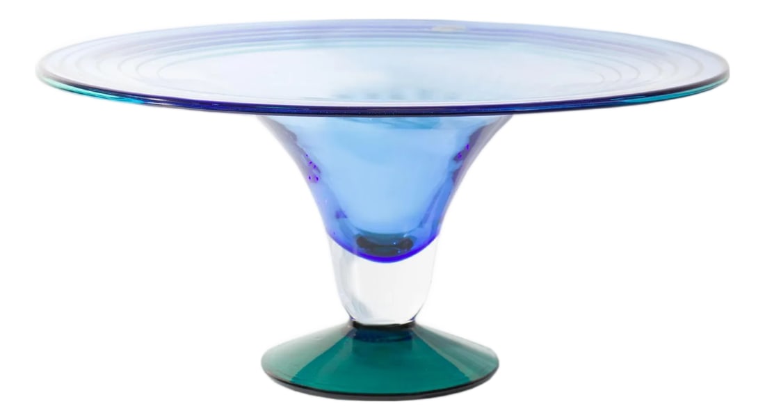Richard Blenko 2000 Glass Compote: A 2000 glass compote designed by American designer Richard Blenko and produced by Blenko. The compote features a flat wide mouth and bowl in pale blue with a clear stem and darker turquoise base. Ther