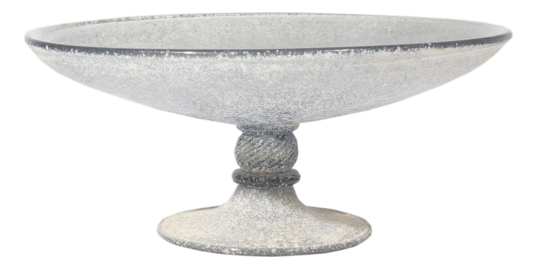 Gray Scavo Art Glass Compote: An art glass compote. Made of gray scavo glass, this compote has an oval bowl top with round pedestal below topped with a diagonally ribbed round accent. The compote is unsigned. Condition: