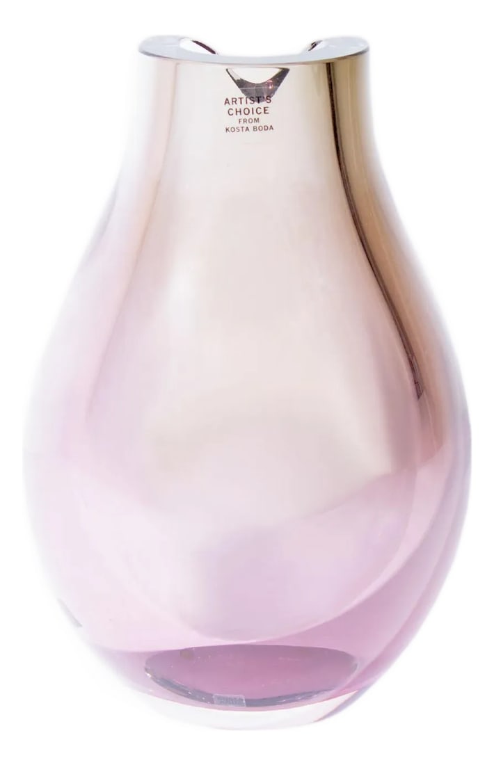 Goran Warff Kosta Boda "Opus" Glass Vase: A glass "Opus" vase designed by Swedish glass artist and designer Goran Warff (born 1933) for Kosta Boda. Made in Sweden, this vase is made from a pale purple glass and has a teardrop shape with a