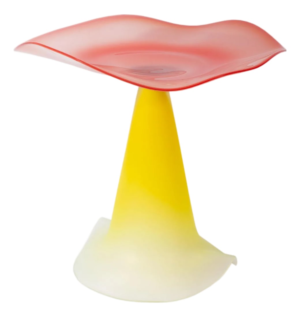 Stephan Cox 2001 Postmodern Art Glass Compote: A 2001 art glass compote by the American glass artist Stephan Cox (born 1956). This delicate work features a red-pink undulating top that sits upon a cone-shaped base with flared edges. The bottom edg