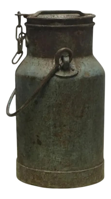 Mid 20th Century Indian Metal Container: This antique metal milk drum was handmade in India. The jugs were typically used to transport and deliver milk. The tapered shape kept the metal drum from tipping during railway and wagon transport,
