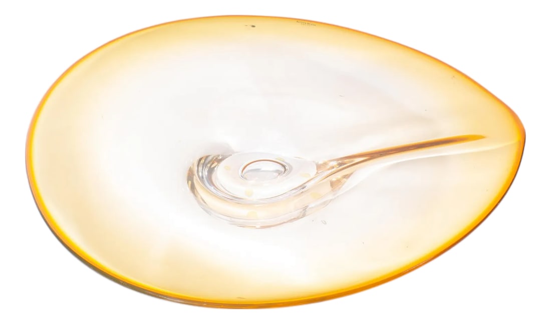 Goran Warff Kosta Boda Centerpeice Bowl: A gradient yellow-orange centerpiece bowl designed by Swedish artist Goran Warff (1933-2022) for Kosta Boda. Made in Sweden, this bowl has a teardrop shape, growing in a darker shade of yellow-orange