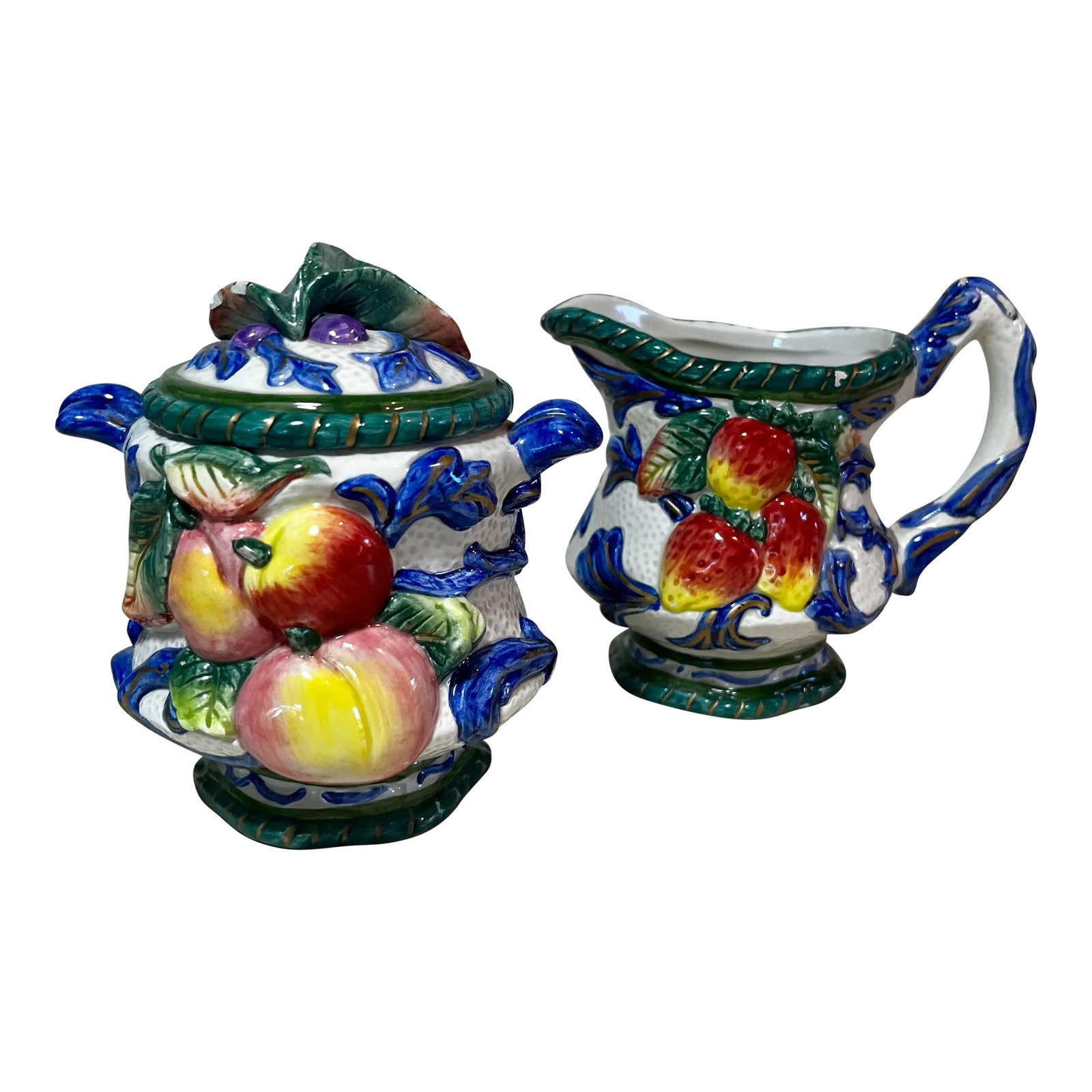 Vintage Fitz and Floyd Florentine Fruit Cream and Sugar Set- 2 Pieces: Vintage Fitz and Floyd Cream and Sugar set in vivid "Florentine Fruit Blue" . Shows various fruits in relief against a blue and white background. Makers mark stamped on the bottom of each. FITZ AND