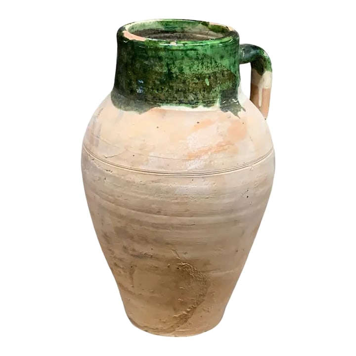 Vintage Turkish Terracotta Oil Jar: Hailing from the mountains of Anatolia and Konya in Turkey, these oil jars have a very transitional appeal. Each one is so wonderfully unique with its glaze and terra cotta color. You are buying a pie