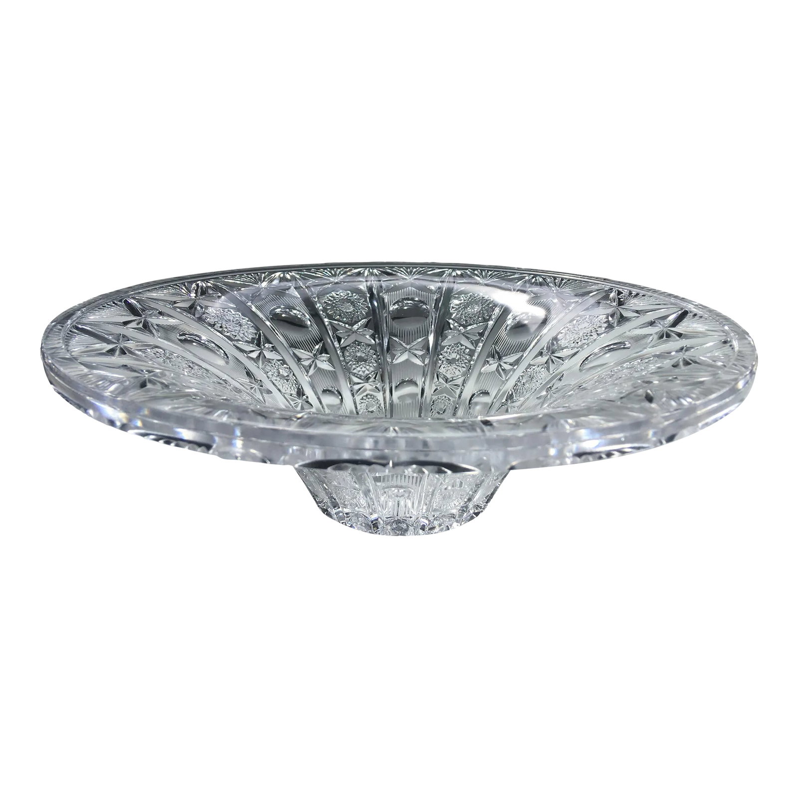 Vintage Brilliant Cut Crystal Centerpiece Bowl: An early 20th century heavy glass bowl with an elaborate design which catches the light in a striking manner. It is patterned with alternating rows of starbursts, circles, crosses and floral shapes