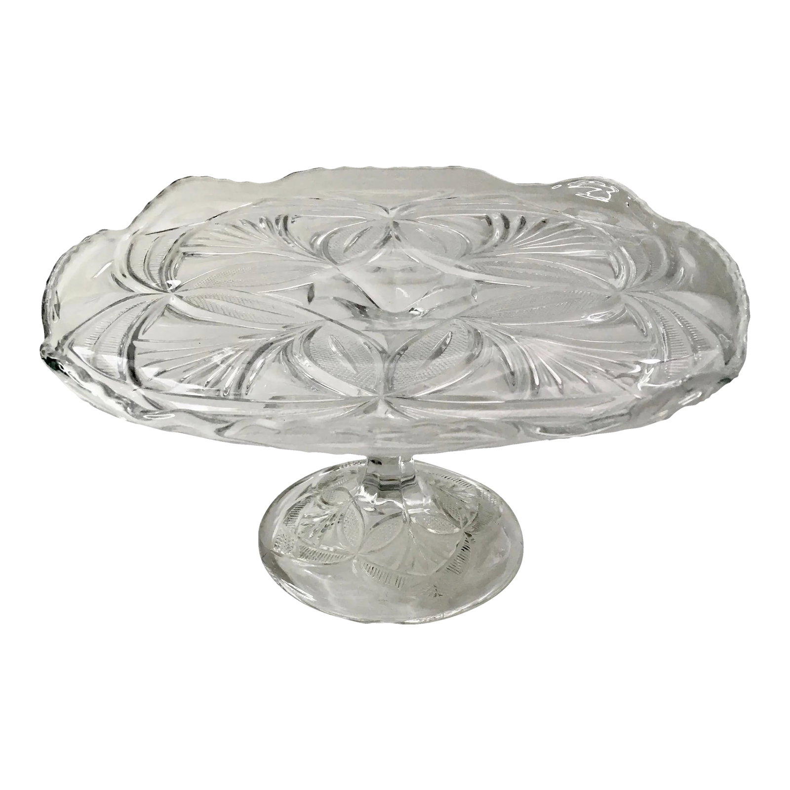 Early 20th Century Geometric Pressed Glass Cake Stand: An antique serving stand in a beautifully elaborate pattern which would add an elegant note in a variety of situations. Ships within 1-2 days using USPS. Arrives within 2-5 business days after