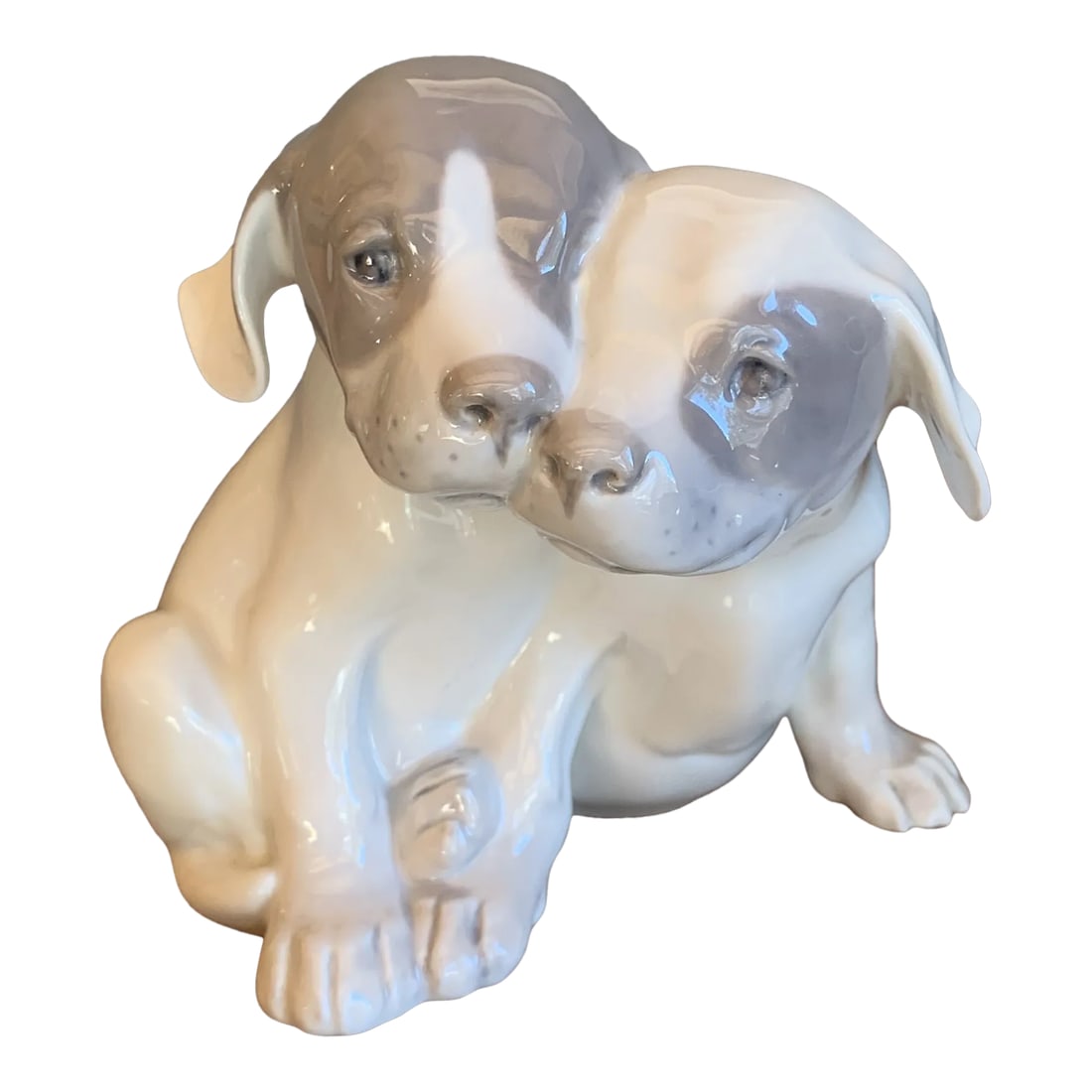 Vintage Royal Copenhagen Porcelain Puppies Figurine #260 Circa 1960's: Adorable porcelain figurine of snuggling pointer puppies. First made by Royal Copenhagen in 1964, this wonderful dog figurine measures a full 6'' tall x 6 3/4'' long x 5'' wide. It is in excellent