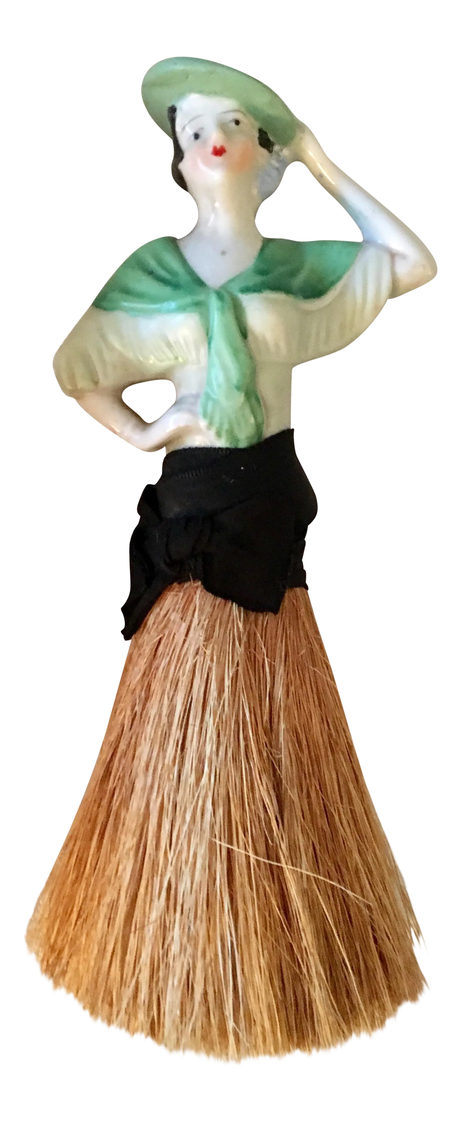 1920s Art Deco German Half Doll Ceramic and Straw Brush: This is a German antique clothes brush with a 1920s ceramic half doll as a handle. The brush is straw. The lady is wearing a green top with green shawl and a green hat She is posing with her hand on