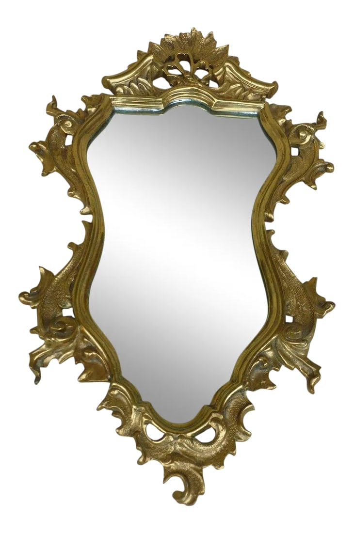 Turn of the Century Bronze Wall Mirror With Scrolled Cartouches: Turn of the century bronze wall mirror with scrolled cartouches sold as found estate fresh measuring 32 inches long x 19 inches wide . Mirror is somewhat loose and will need to be tightened, there is