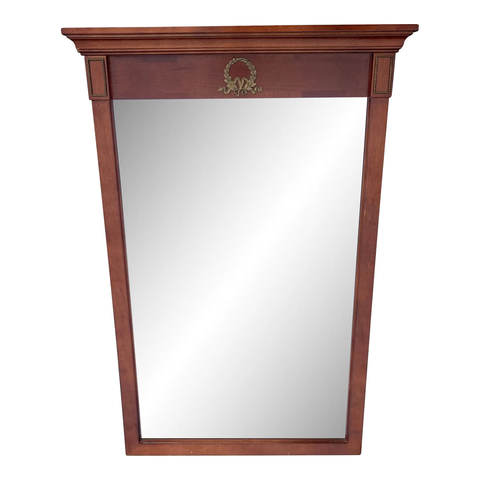 Vintage Bombay Company Cherry Trumeau Beveled Mirror: 1996 Bombay Company rectangular beveled mirror. Has laurel leaf wreath metal applique in center with rectangular metal appliques on each side. Measures 25.75 wide with top trim otherwise it is 23"