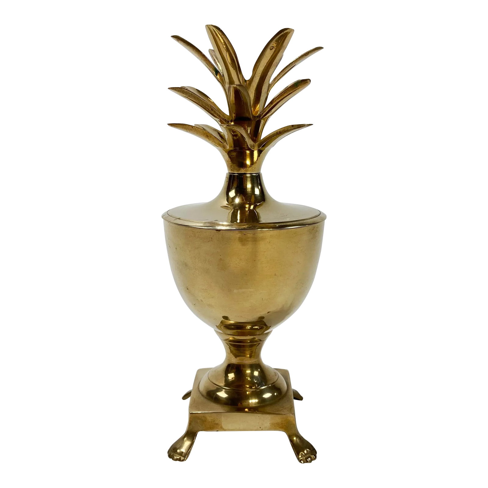 Vintage Hollywood Regency Style Brass Pineapple Urn: Vintage Hollywood Regency style brass pineapple lidded urn featuring claw feet and exaggerated plume. Top can hold a single taper candlestick. Lovely patina. Condition: Alterations: Original