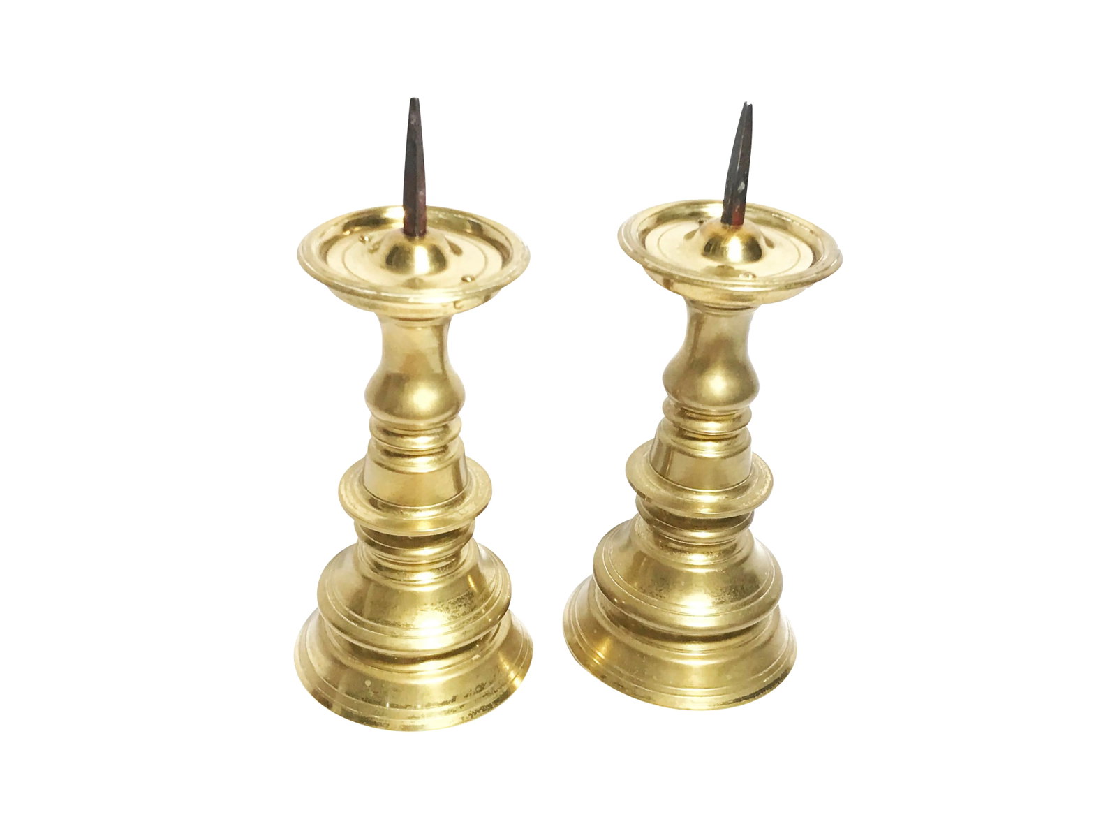 1960s Hollywood Regency Solid Brass Candle Holders - a Pair: Vintage pair of mid century solid brass candle holders. This beautiful pair is substantial, heavy solid brass. The pieces have piliar shaped bodies and candle stakes on the tops to hold your candles i