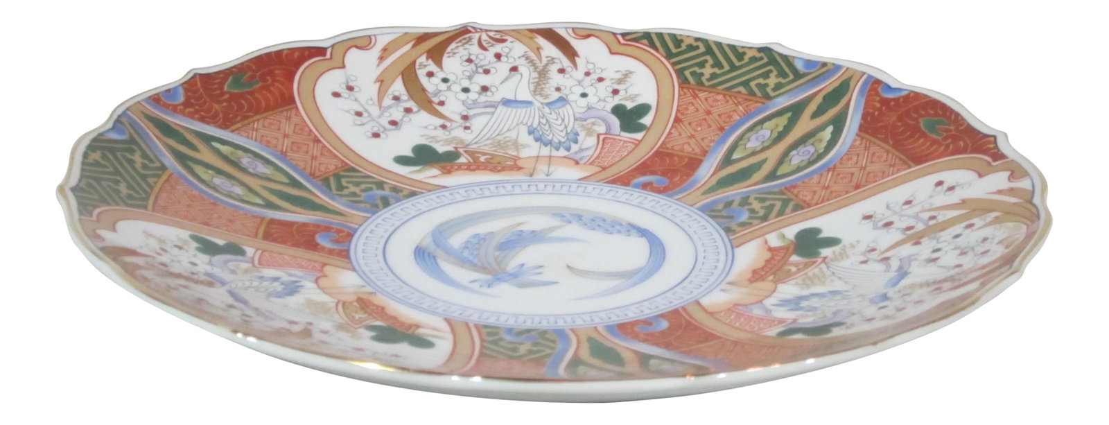 Contempory Imari Style Plate: Hand painted Imari pattern plate decorated with Crain's, florals and geometric patterns. The plate has a scalloped rim with gold trim. Condition: Alterations: Original Condition Unaltered