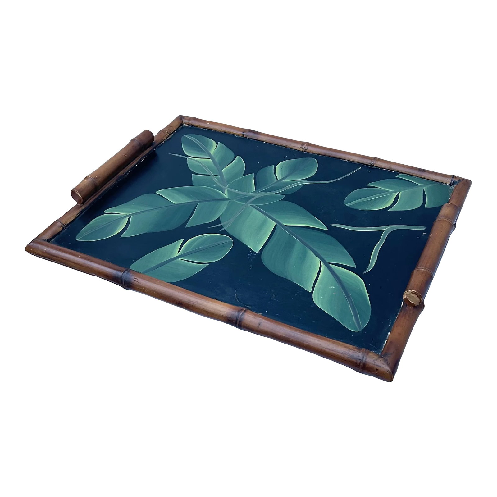 Vintage Palm Regency Faux Bamboo Tray With Painted Palm Leaves: This handsome vintage wooden tray is inspired by chinoiserie design with edges and handles carved to resemble bamboo. The surface of the tray has lush green leaves painted on it. As functional as it