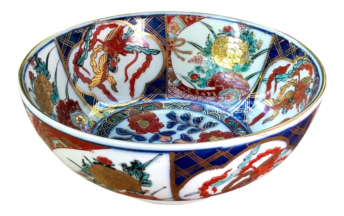 Japanese Hand-Painted Gilt Porcelain Imari Bowl: A bold decorative catchall bowl sure to catch some attention! This is hand decorated on both the inside and the outside. Traditional floral and geometric motifs throughout. Excellent condition.