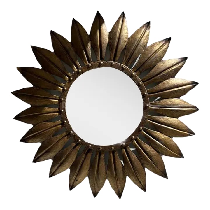 Early 20th Century Large Gilded Iron Leaf Mirror: Attention-getting round "sunburst" mirror in gilded iron. Sunburst mirrors date back to Louis XIV, known as the "Sun King", and as the story goes, he used to stare into his sunburst mirror each