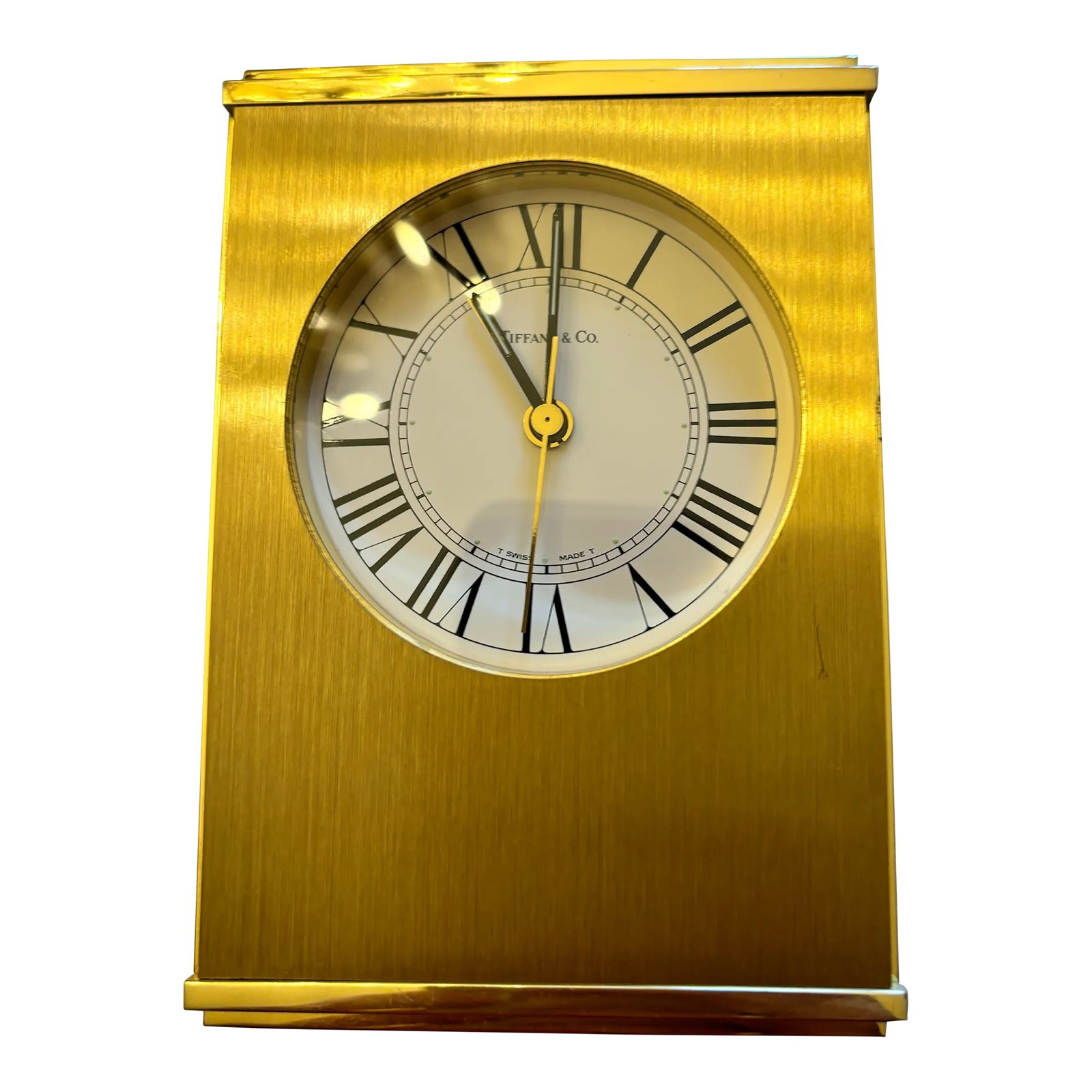 Vintage Tiffany & Co. Swiss Brass Quartz Desk Alarm Clock, Roman Numeral Dial, 1970s: An elegant vintage Tiffany & Co. brushed brass desk alarm clock dating to the 1970s, featuring a distinctive half-moon case, Swiss quartz movement, and crisp white Roman numeral dial. This