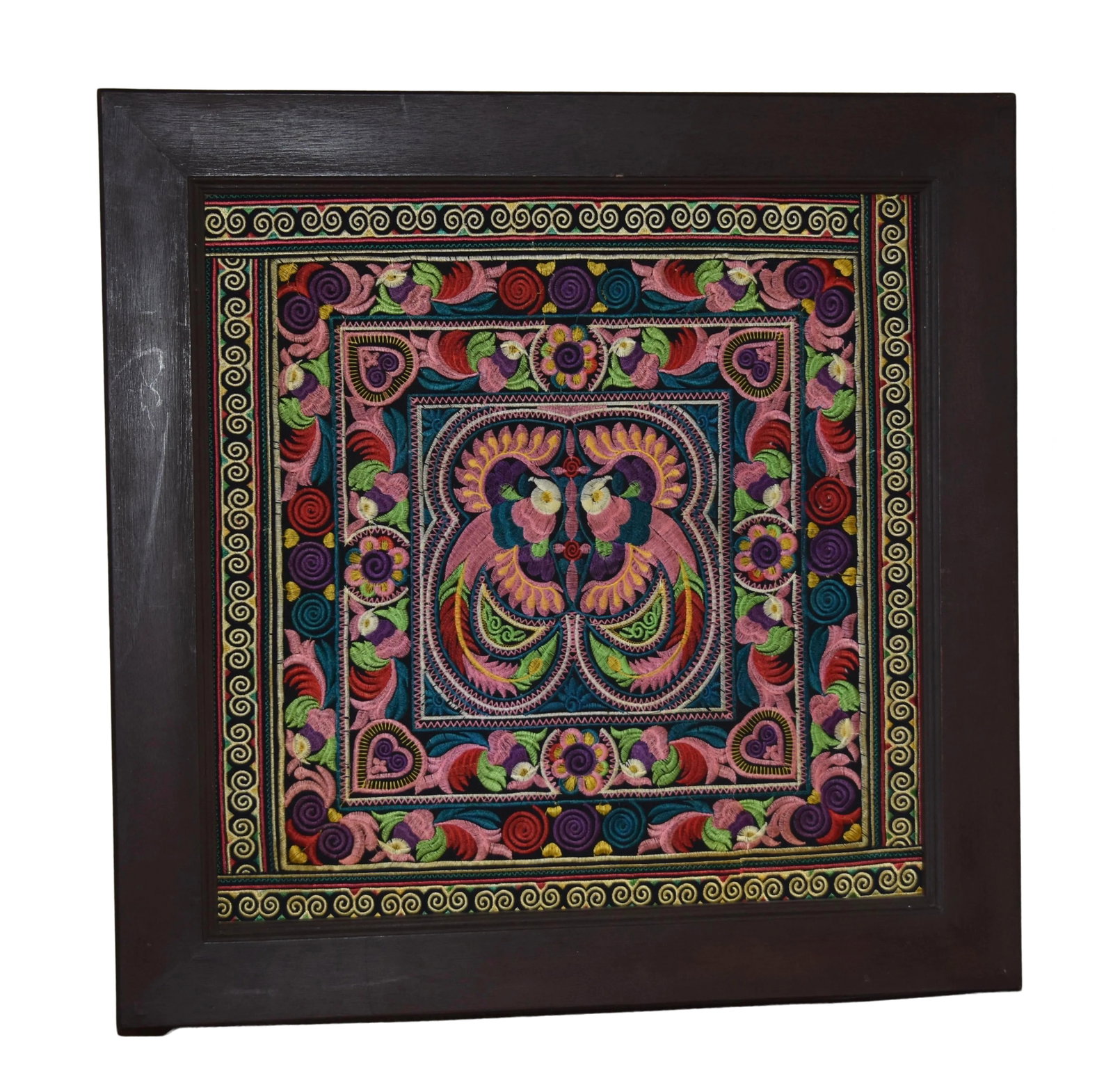Vintage Mexican Folk Art Embroidery Otomi Mounted & Framed: A colorful and whimsical late 20th century Mexican Otomi textile with hand embroidered. The designs are detailed and stunning bright colors. This piece depicts a center peacocks surrounded by florals 