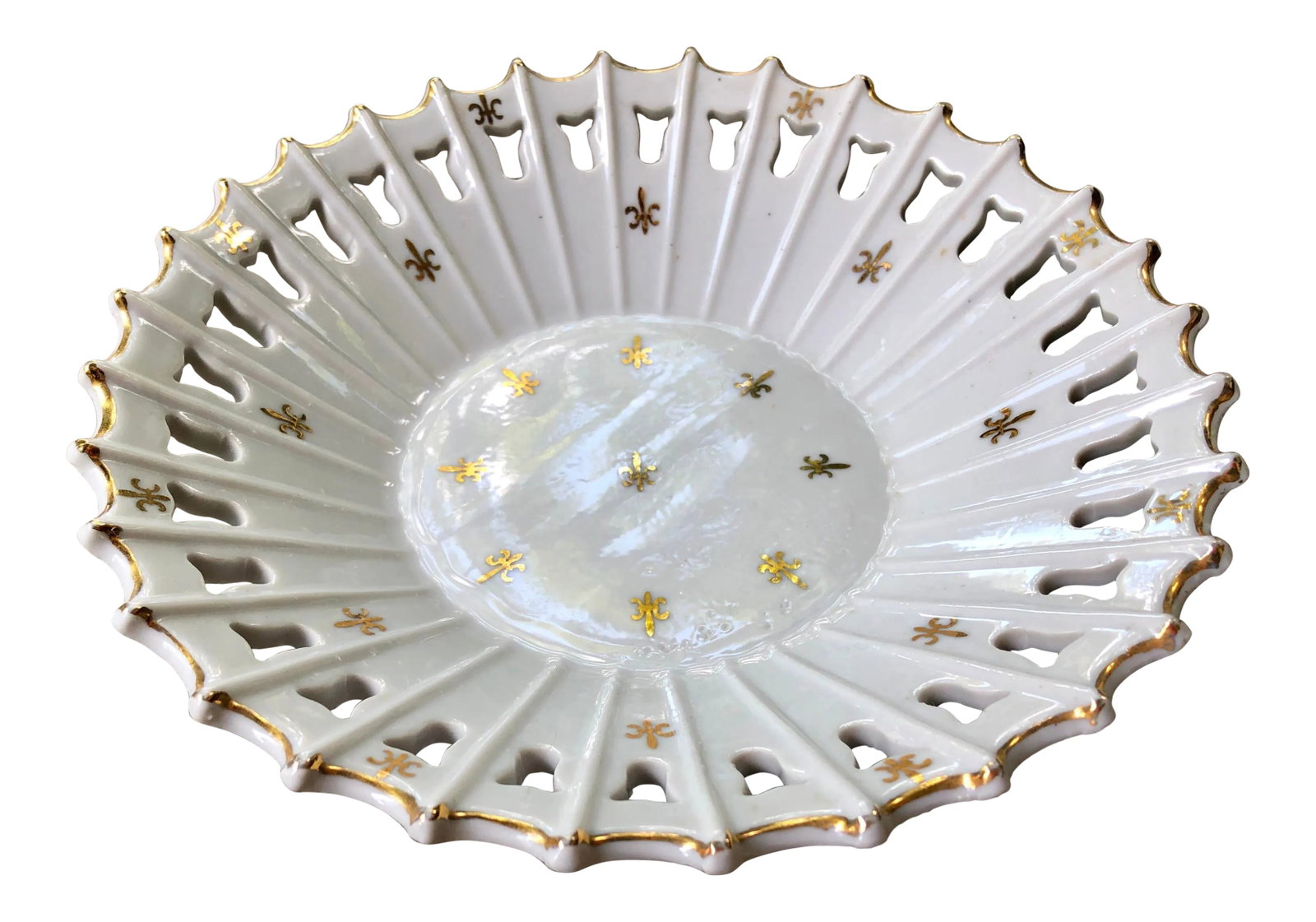 White Porcelain Reticulated Bowl With Gilt Fleur De Lis: A stunning decorative bowl with lattice edging. Allover gold fleur de lis motifs and gilt edging. A perfect catchall dish in any room. Condition: Alterations: Original Condition Unaltered