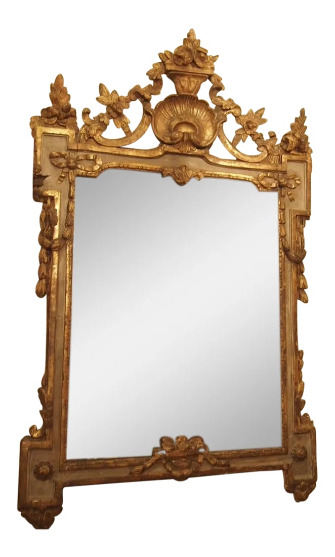 Period Louis XVI Mirror With a Shell Cartouche: $8,500.00 An 18th century Louis XVI mirror with a pierced, finely carved cartouche centered with a scallop shell. This mirror represents the transition between the Louis XV and Louis XVI style, the mu