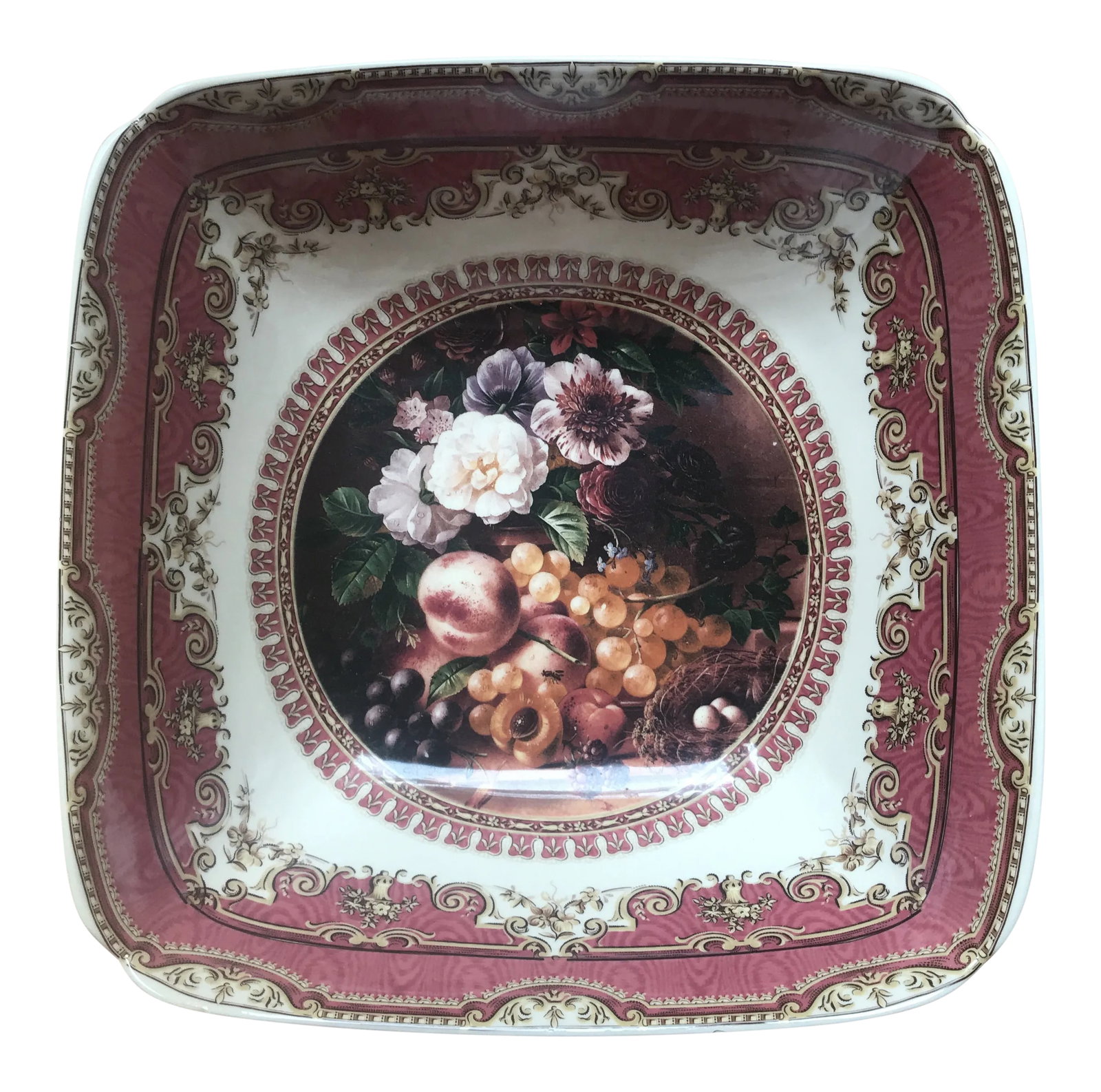 Large Porcelain Fruit Bowl: Lovely square porcelain decorative bowl covered in beautiful detailing, with scrollwork, and a large center medallion still life of flowers and fruit. Condition: Alterations: Original Condition