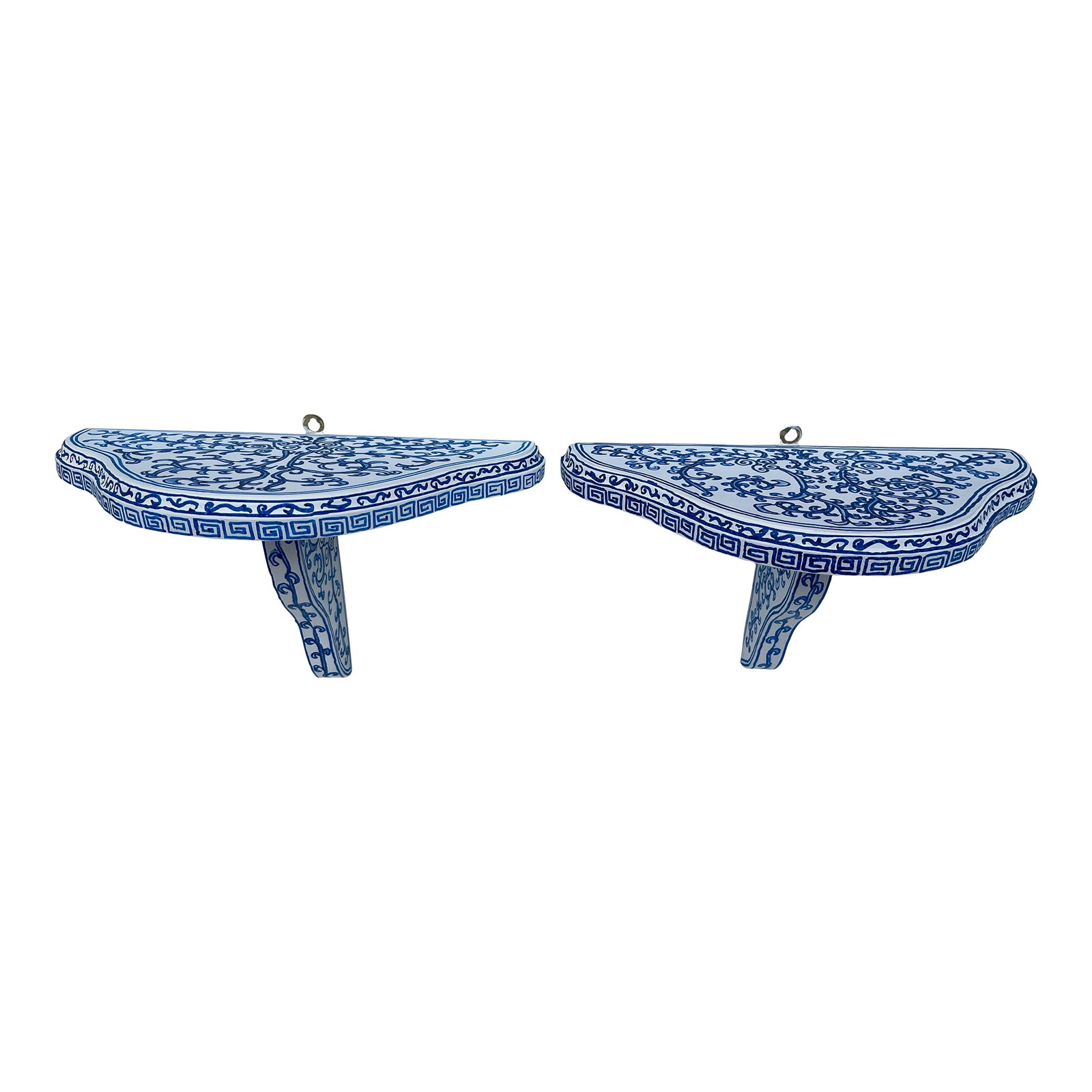 Blue and White Chinoiserie Wall Shelves a Pair: A matching pair of curved wood wall brackets or shelves featuring hand painted floral decoration in the manner of Chinese blue and white porcelain. Condition: Alterations: Original Condition
