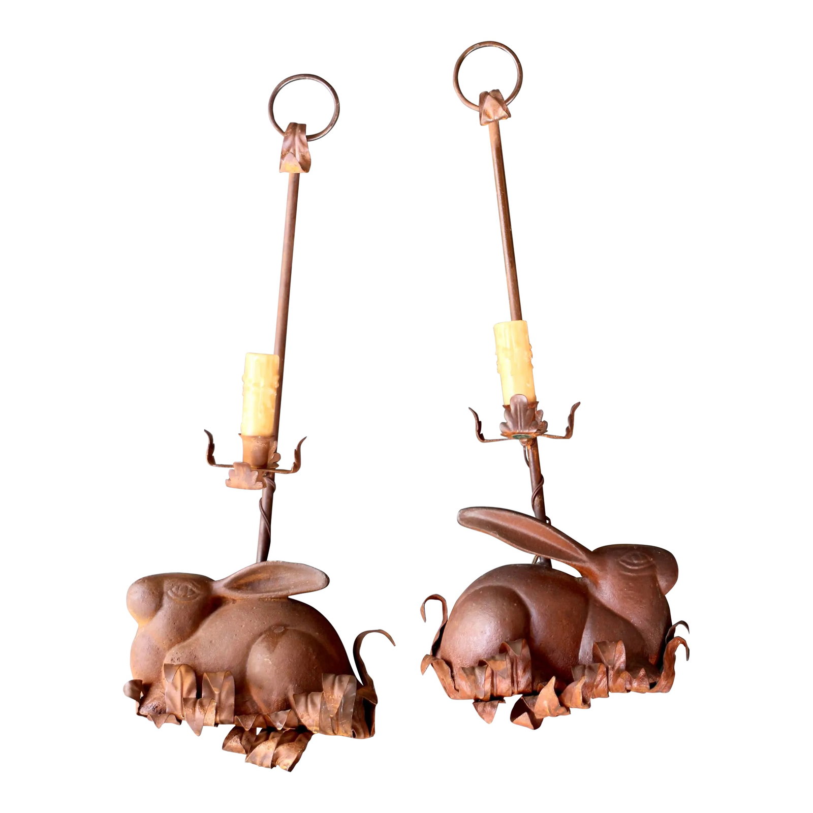 Pair of 1960s Cast Iron Rabbit Electric Candle Sconces: Heavy and substantial cast iron pair of rabbit sconces with candle lights. Orange red rust color. To be installed in the wall. Electric drip candles with a rabbit base with leaves. Hung by a metal