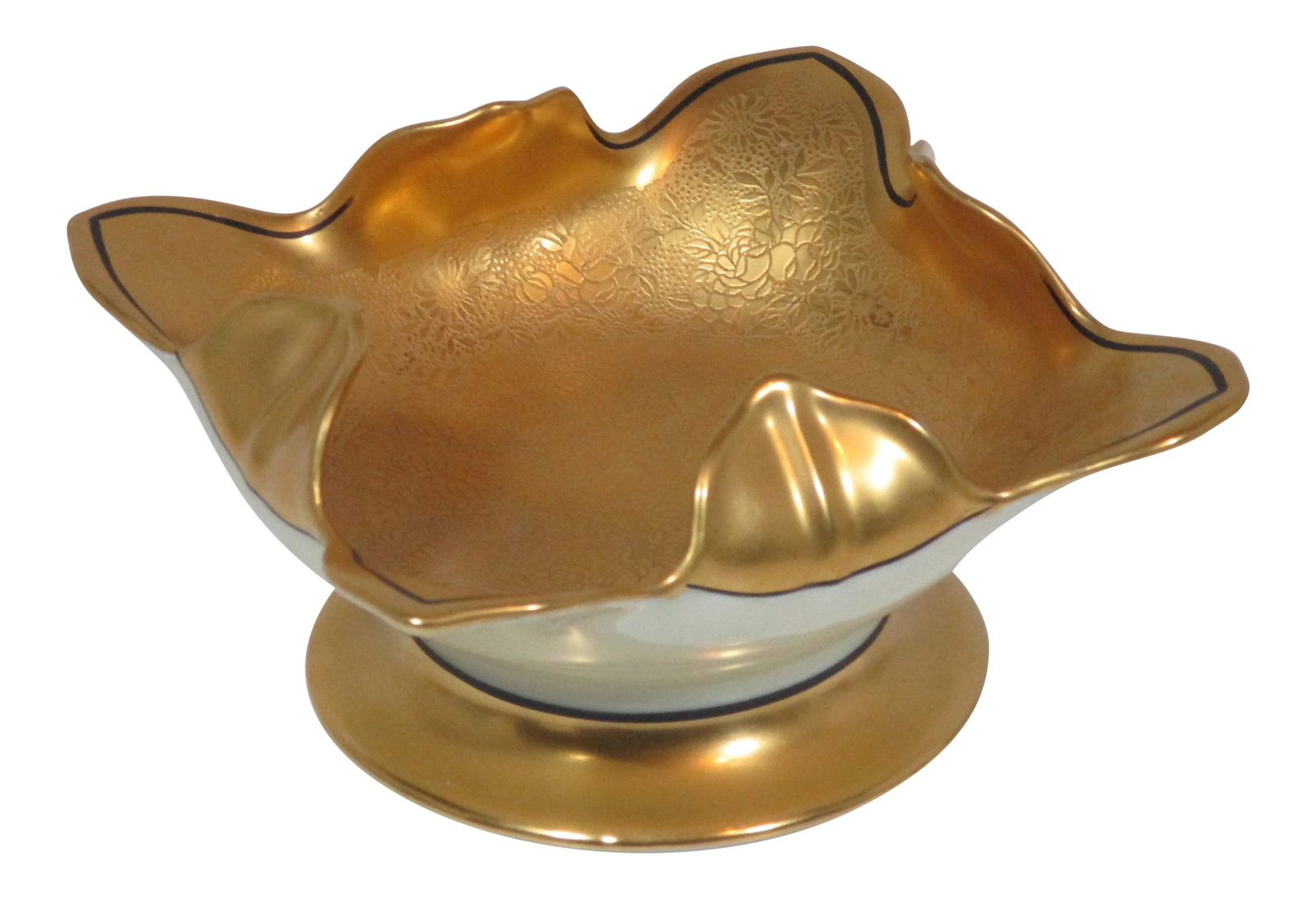 Noritake Lotus Shaped Bowl: This Noritake bowl has a lotus shape top on a pedestal base. The gold interior of the bowl is decorated with an embossed floral and leaf pattern with a black trim along the edge. The outside of the