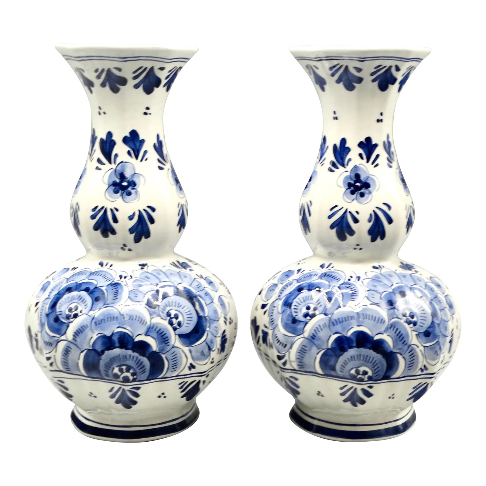 Lobed Bulbous Dutch Delft Vases Hand Painted, a Matched Pair: A lovely pair of hand painted lobed Dutch Delft vases 10.5 inches in height. They are a matched pair of faience vases with a bulbous shape and painted in the traditional colors of blue and white.
