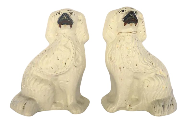 19th Century English Staffordshire Spaniels Dogs White Gilt Highlights Collar - A Pair: Pair of 19th century English Staffordshire spaniels dogs. Originally used on mantels the dogs pair by facing each other. Measure 8 1/2" x 101/2". Some wear to glaze. Container. A Condition: