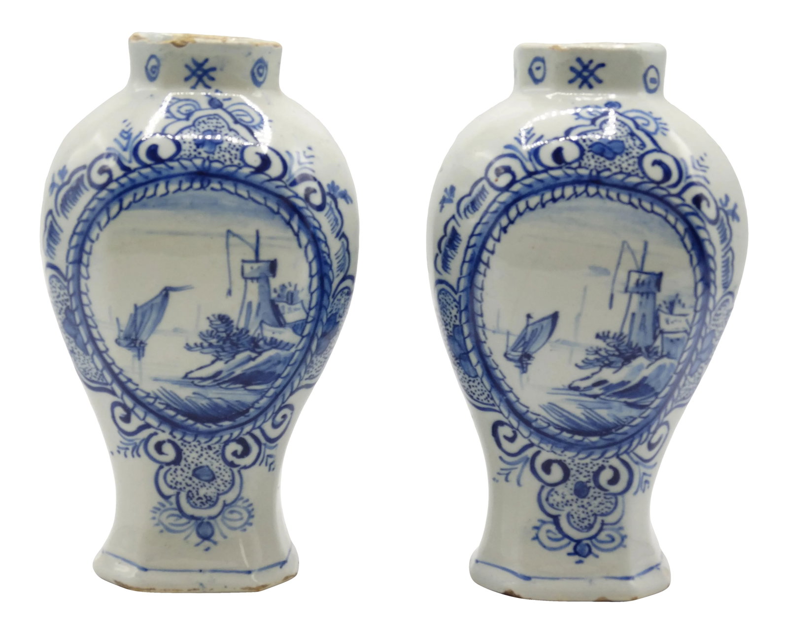 18th-Century Dutch Delft Vases, Maker's Mark: Antique 18th-Century pair of Dutch Delft baluster vases with a landscape and water scene inside a center cartouche. They are accented with a surround of floral, foliate and geometric designs. These fi