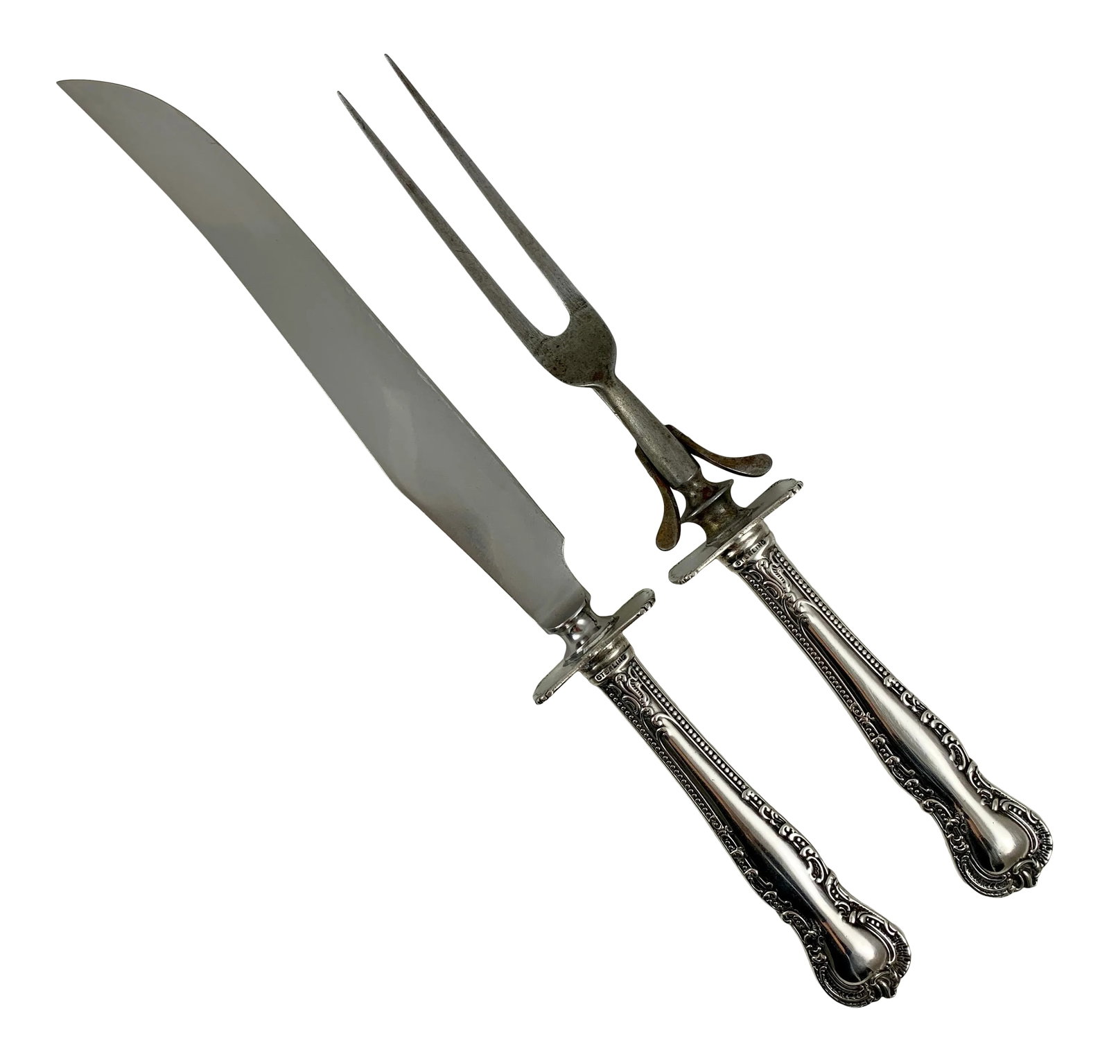 American Sterling Silver Handled Carving Knife and Fork, Set of Two, Circa 1930s: An American two-piece sterling silver hollowware carving set - pattern and maker unknown, circa 1930s. The knife has a stainless steel blade, the fork has a swing support to keep your table linen