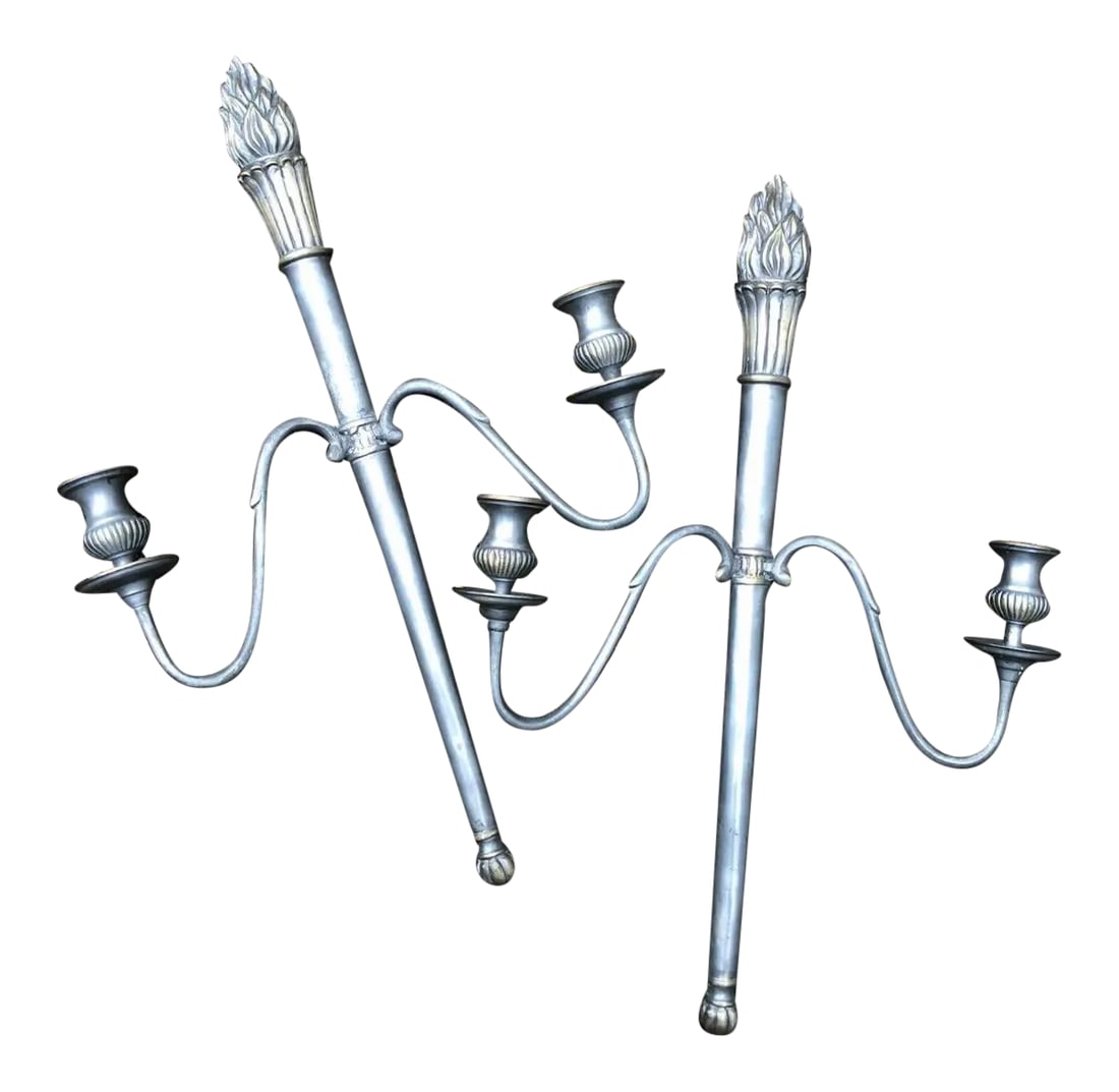 Mid 20th Century Cast Metal Two Arm Torchiere Flame Torch Candle Wall Sconces - a Pair: Lovely pair of vintage torch light wall sconces. 21" tall and about 13.5" wide. No markings. Condition is very good without damage. Flame has a light gold wash. Candle holders screw off. These appear 