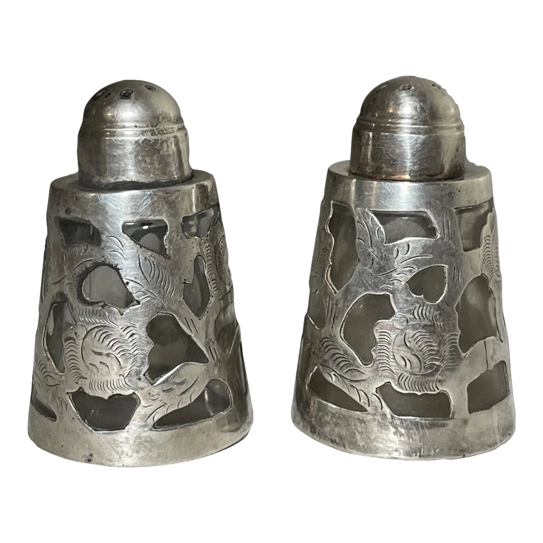 Pair Vintage Mexican Openwork 925 LHM Sterling Silver Glass Salt & Pepper Shaker: Discover the charm of Mexican craftsmanship with this pair of openwork salt and pepper shakers. Made by LHM, these sterling silver pieces feature intricate floral patterns that showcase the fine