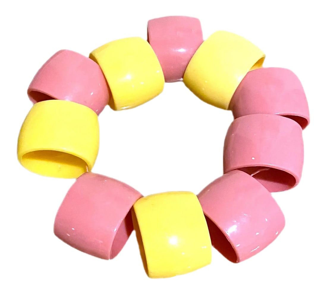 Postmodern Pastel Napkin Rings: A fun mix of pastel pink and yellow plastic napkin rings. They are oval in shape. There are 6 pinks and 4 yellow. Condition: Alterations: Original Condition Unaltered Imperfections: Some Imperfections