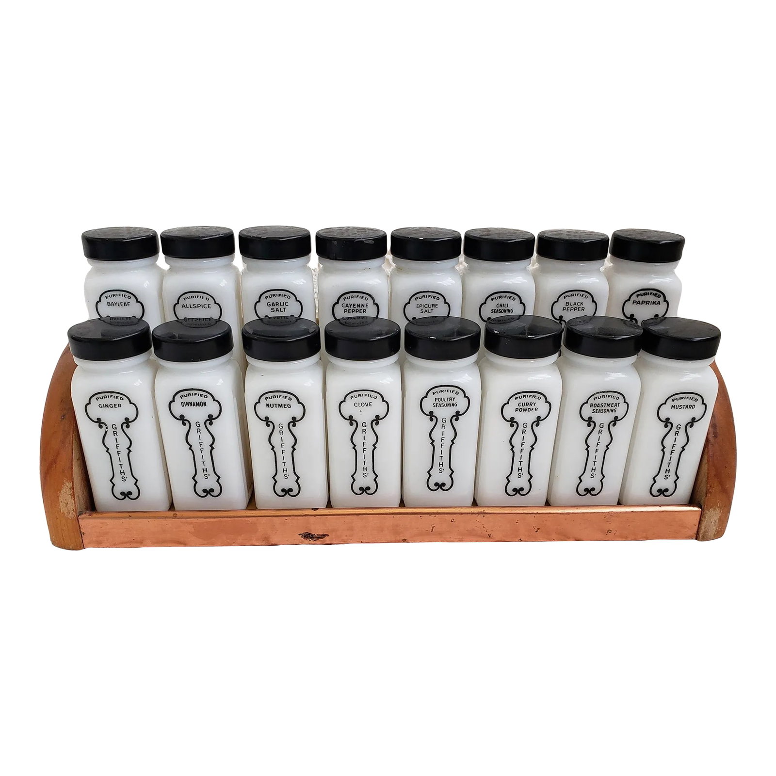 1940s Black and White Griffith's Laboratories Spice Rack - Set of 17: A set of 16 black and white Griffith's Laboratories spice rack. Made in Chicago, Illinois. The stand measures 13 1/4" x 3 1/2" w x 5 1/4" h and the bottles and labels are in very good vintage conditio