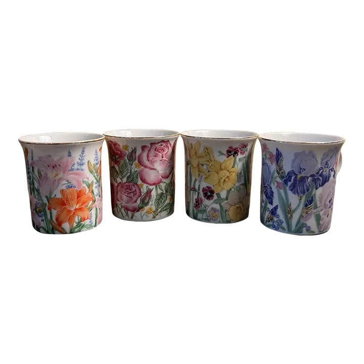 Lenox Bone China Mugs "The Flower Blossom Mug Collection" by Susanne Clee: Lenox bone china mugs "The Flower Blossom Mug Collection" by Susanne Clee. Includes the four mugs "Daffodil", "Day Lily", "Iris", and "Rose". Each mug has a height of 3.625" and a width of 4.5".