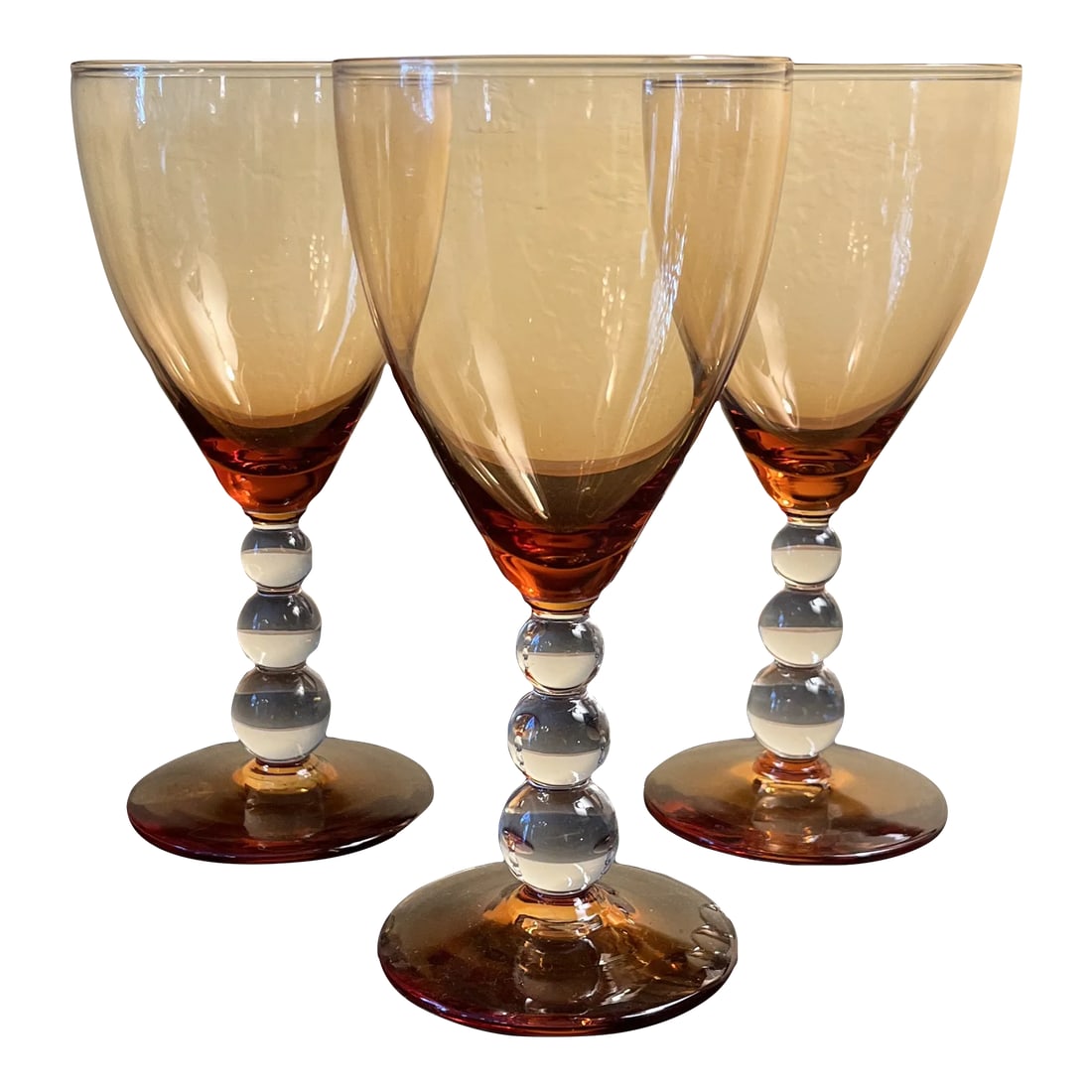 Amber Glass Goblets With Bubble Stem- Set of 3: Amber glass goblet with bubble stem. Set of 3. Circa 1950s/60s. Has a height of 7" and a diameter of 3.25". Used, but in very good condition. Condition: Alterations: Original Condition Unaltered