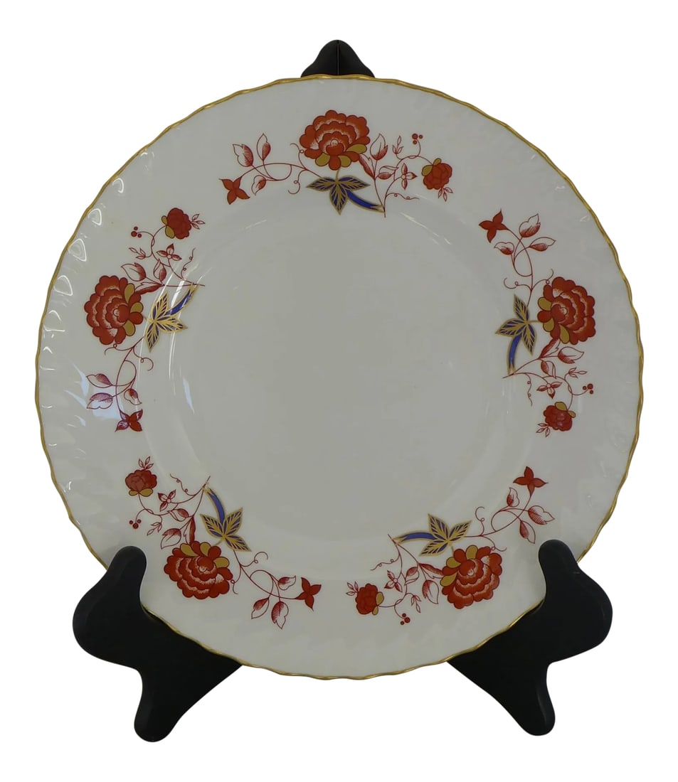 English Bone China Plate: Hand painted gold trimmed dinner plate. Maker's Mark reads" Royal Crown Derby, Bone China Made in England" with red flowers and flourished surrounding edge, plate stand is not included. In excellent