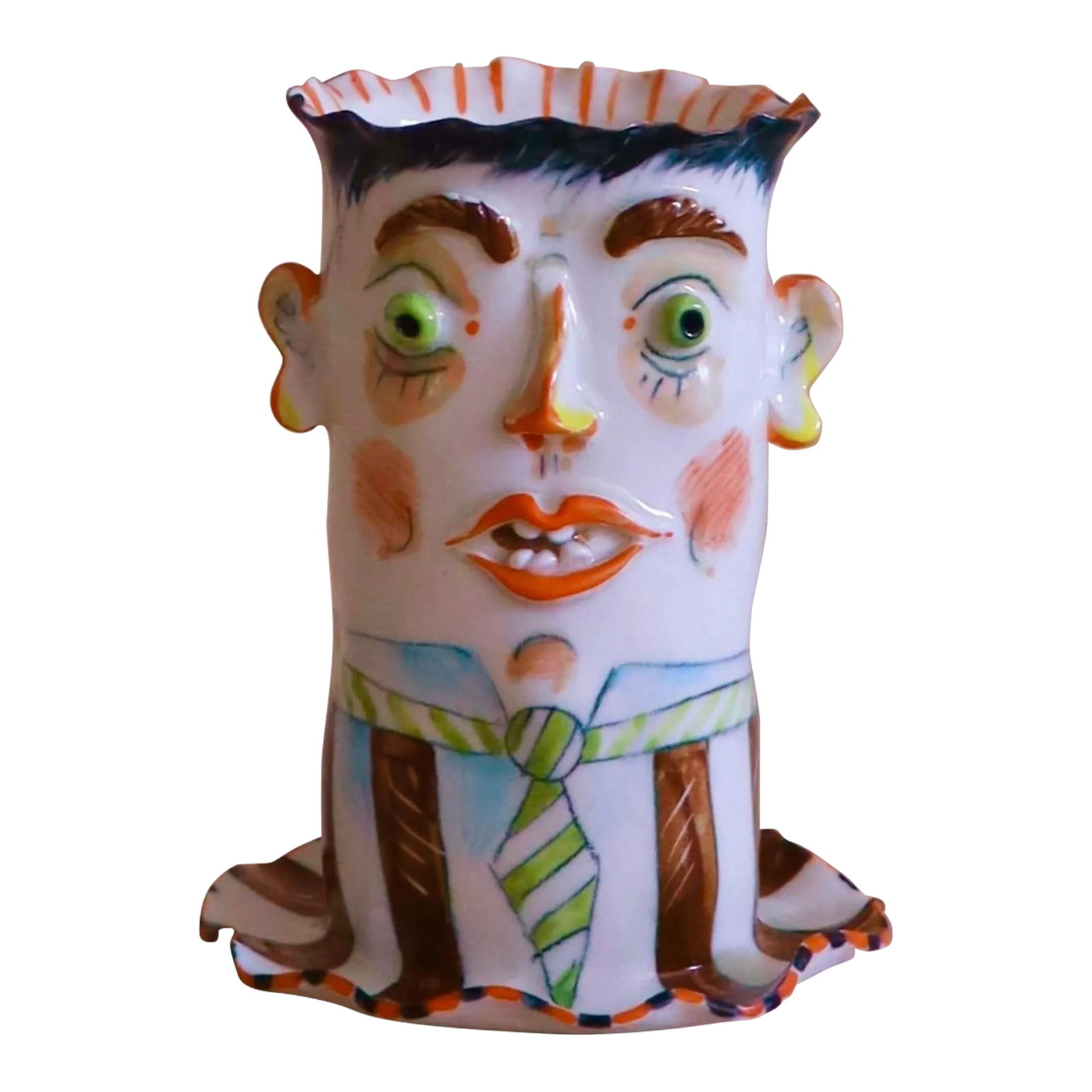 Petite Head Vase: Petite porcelain vase with incredible detail work. Features expressive, wacky face with carefully crafted protruding eyes, nose, ears, lips and teeth. Meticulously and vibrantly painted details - from