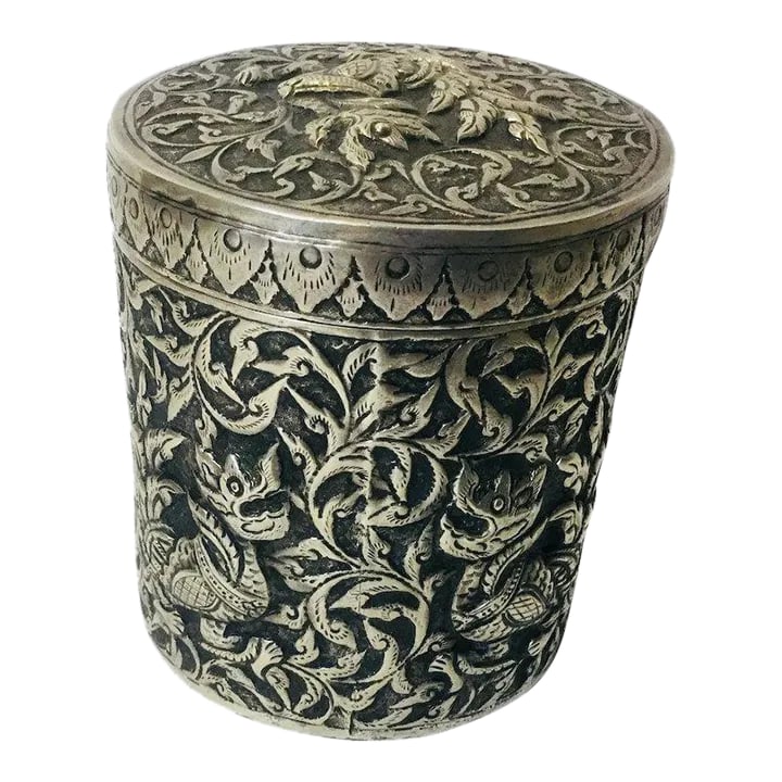 Chinese Silver Hand Chased Covered Jar With Foo Dogs: Silver signed hand chased covered with. jar Foo Dog and floral design. Mint condition. Measures three inches in diameter and three and a half inches tall. Signature on bottom. Condition: Alterations: 