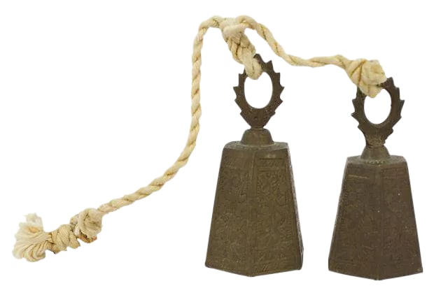 Engraved Brass Bells - a Pair: Pair of engraved brass bells on rope. Made in India. Light tarnish. Smaller bell, 2"Dia x 3.5"H. Condition: Alterations: Original Condition Unaltered Imperfections: Some Imperfections Condition