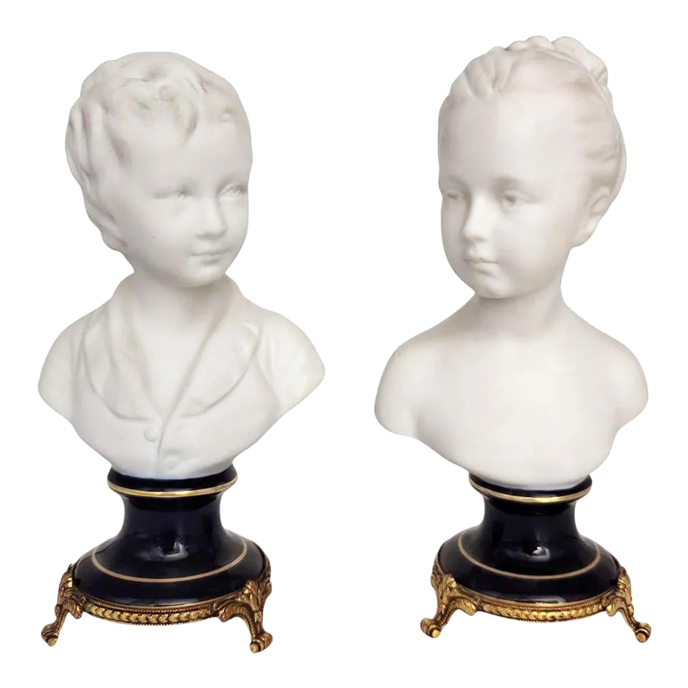Limoges Bisque Porcelain Brongniart Children Busts After Houdon by Tharaud, a Pair: Rare early 20th-century bisque porcelain busts of Louise and Alexandre Brongniart, after Jean-Antoine Houdon, produced by Camille Tharaud in Limoges, France. Crafted in unglazed white porcelain, each 
