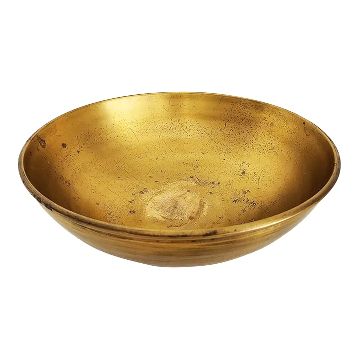1980s Calvin Klein Solarized Brass Offering Bowl: Offered is a sleek and heavy brass bowl with a blackened patina swirl detail on the exterior by Calvin Klein. The exterior has a brushed finish, the interior is polished and shows a fabulous patina.