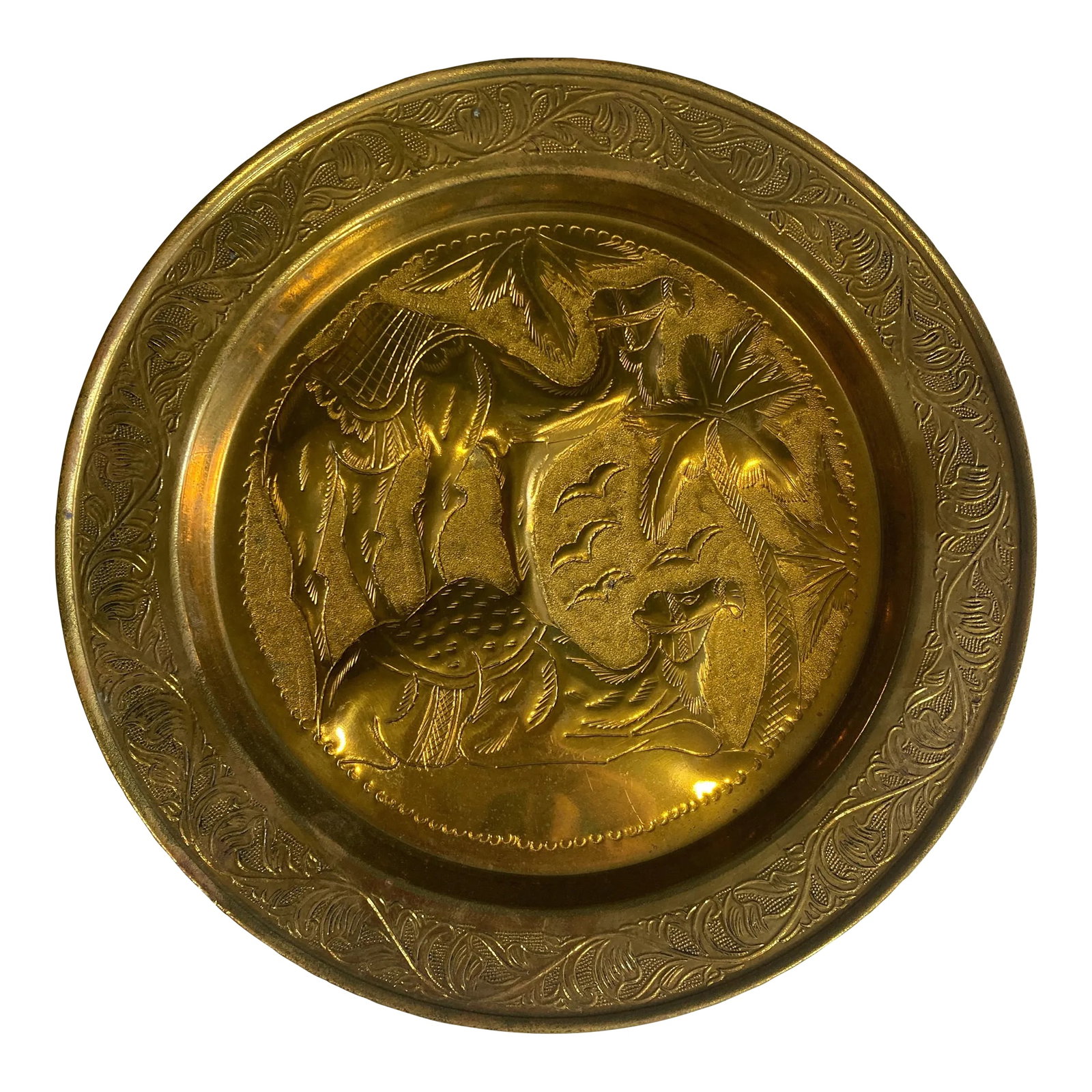 1960s Brass Embossed Camel Plate: This stunning vintage brass decorative plate features intricate etchings of floral and animal motifs, showcasing timeless craftsmanship. Perfect for adding a touch of elegance to your home decor,