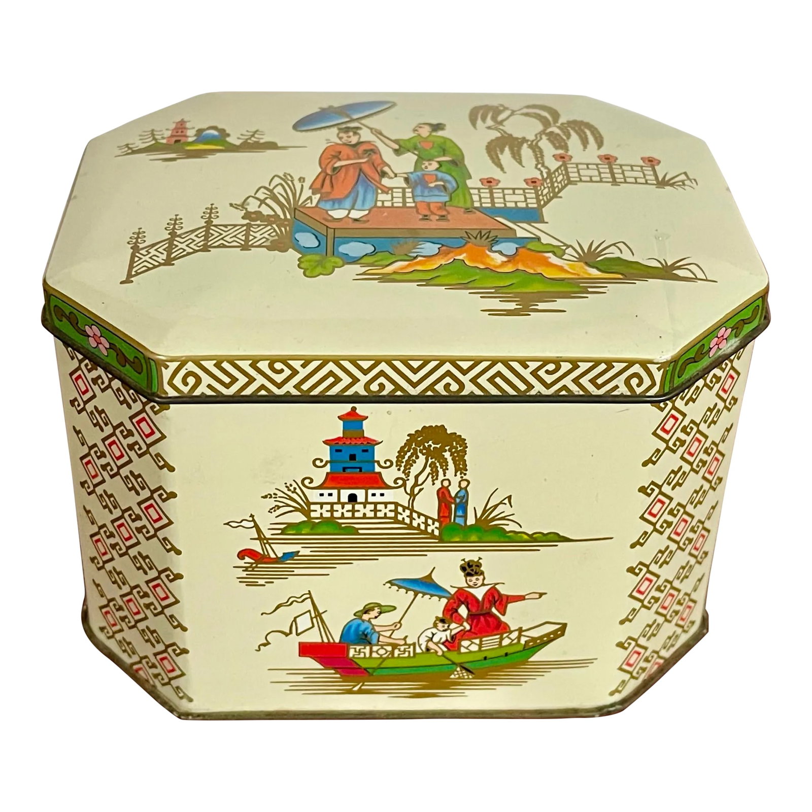 Mid 20th Century Chinoiserie Hinged Tin: A vintage hinged tin box with a garden scene on an ivory background featuring people enjoying themselves amongst beautifully appointed pagodas, fences and sailing boats in a vibrant color palette. The