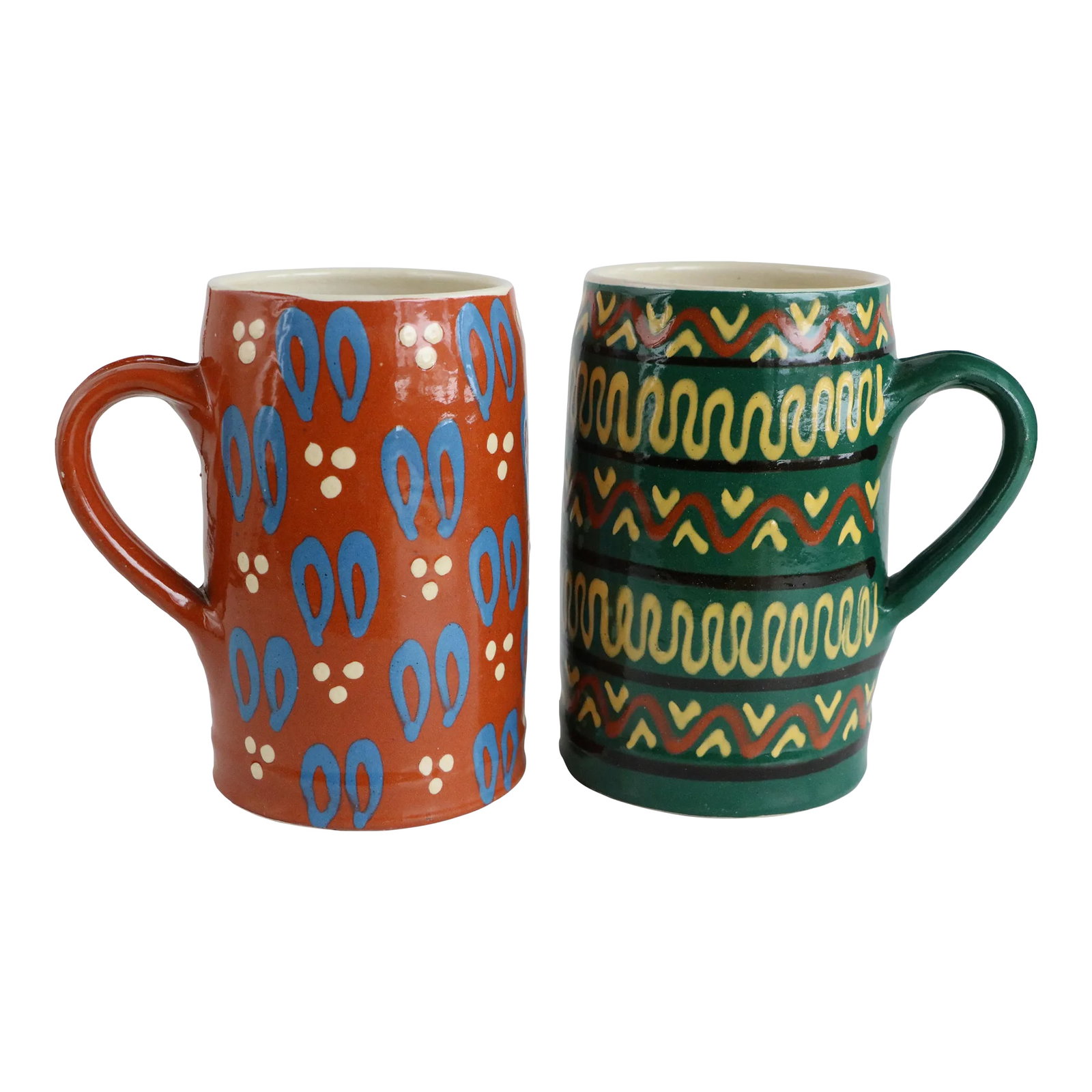 German Slipware Steins - a Pair: Vintage slipware pottery mugs with vivid wraparound traditional designs from Schneider Art Pottery of Marburg, Germany. While intended for ale and the like, these tall open steins function well for a 
