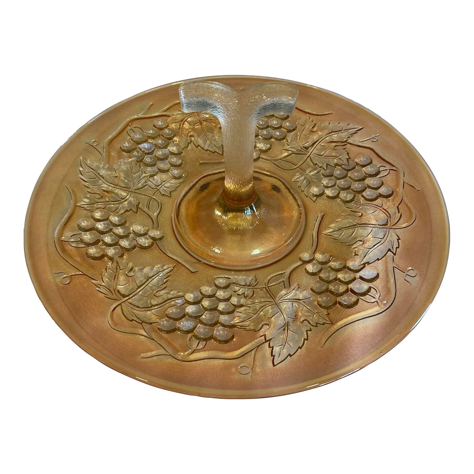 Vintage Amber Iridescent Etched Glass Cake Plate With Handle: This vintage orange iridescent glass cake plate features beautiful etched grape detailing and a charming central handle for easy serving. The vibrant shimmer and warm amber hue catch the light elegant
