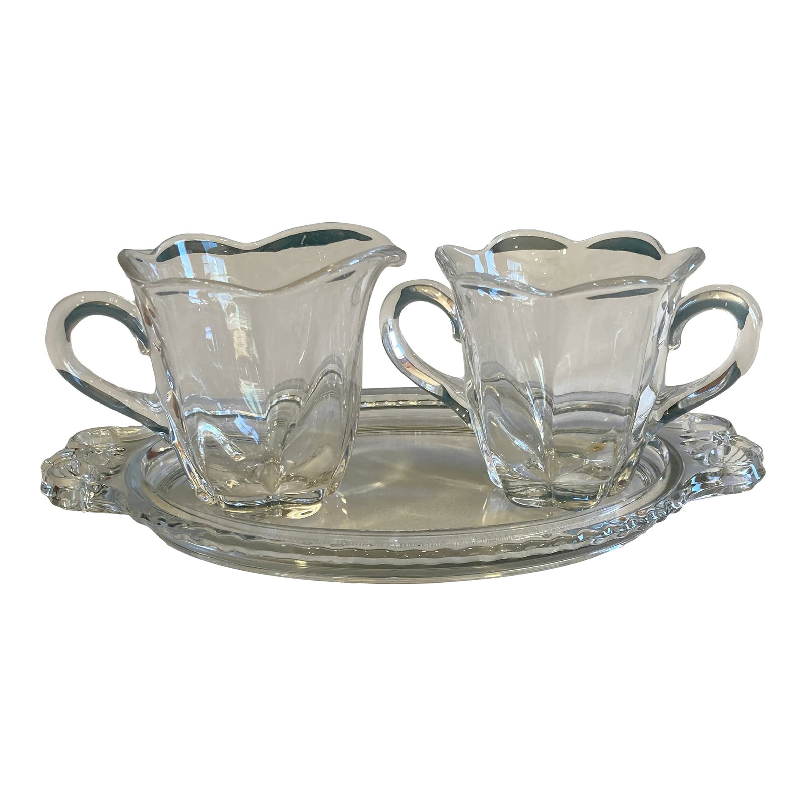 Vintage Clear Fluted Glass Creamer and Sugar Bowl Set With Matching Serving Tray: A charming vintage three-piece clear glass cream and sugar set featuring a matching creamer, open sugar bowl, and coordinating handled tray. The molded glass design showcases graceful scroll handles, 